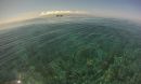 An NSF Moorea Coral Reef LTER site research boat is moored on an outer reef; background is Tahiti.