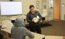 Photo of professor teaching parts of  a skull to a student