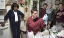 researchers test water in a kitchen while the resident is watching