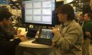 people with computers at a conference