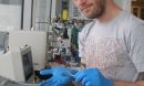 John Chmiola holds an electrochemical capacitor's electrode.