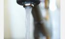 Photo of water coming out of a faucet.