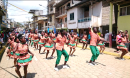 group of people dancing down a street