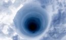View looking down an ice coring borehole atop the Greenland ice sheet