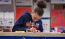 A student calculates measurements in one of the makerspaces involved in Designing for Diversity.