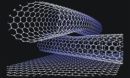 ball and stick model of two crossing carbon nanotubes on a graphite surface.