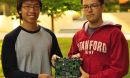 Graduate students Sam Fok and Alex Neckar hold a brain-inspired computational platform