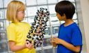 Photo of children talking about a model of a carbon nanotube.