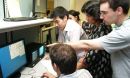 Photo shows Exotic Beam Summer School students viewing progress of their experiments.
