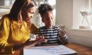Parent helping daughter with math.