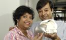 Engineers holding a skull with artificial implant