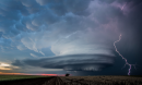 Shelf cloud with lighting over a field