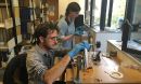 Professor Dustin Schroeder (foreground) and Jessica Daniel splice 50-year-old film
