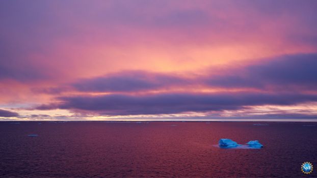 Dramatic image of arctic ice in the middle of arctic ocean with beautiful sky in the background.