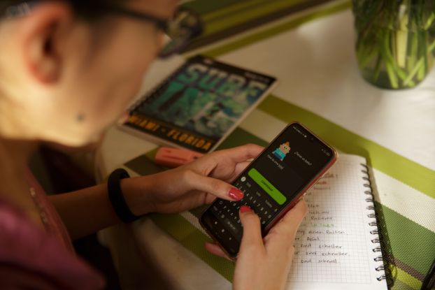 A person types on a cell phone screen