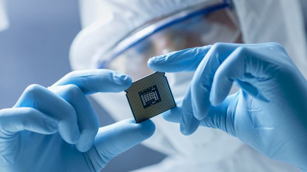 lab worker holds computer chip