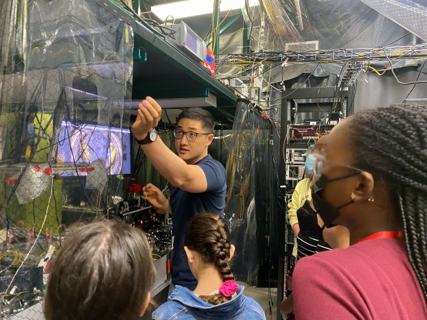 High school students in the University of Maryland's Advanced Physics Summer Girls' Camp view an ion trap