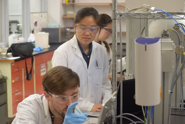 Image of students and professor in a lab setting