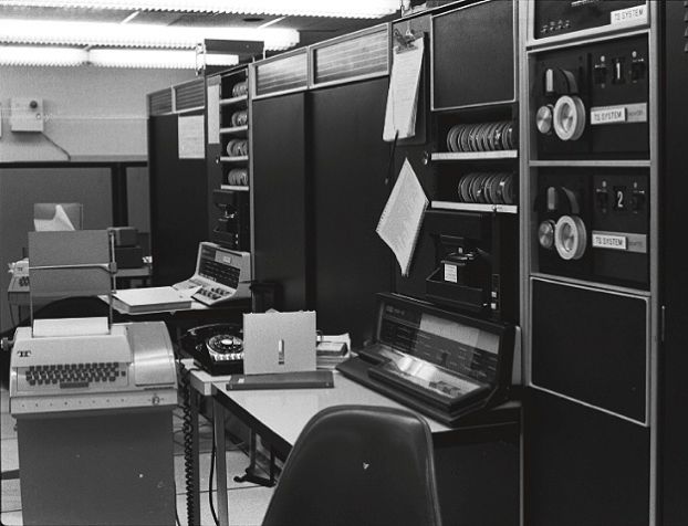 A room filled with large, room-sized computers from the 1970s