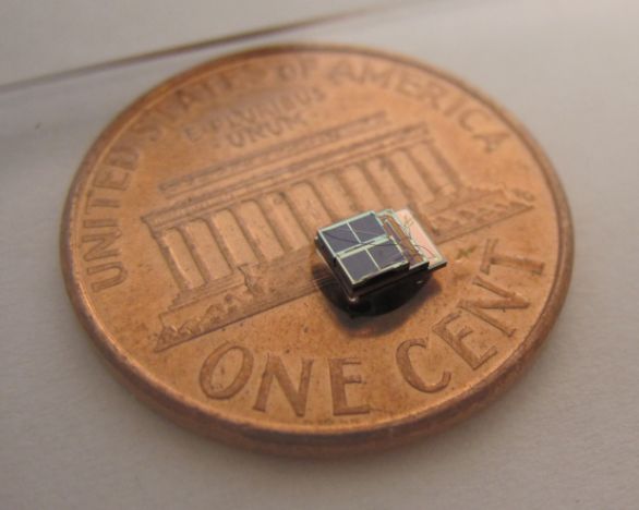 A tiny solar-powered sensor system sits on a penny.