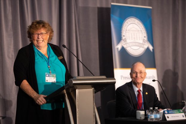 A speaker at a podium.