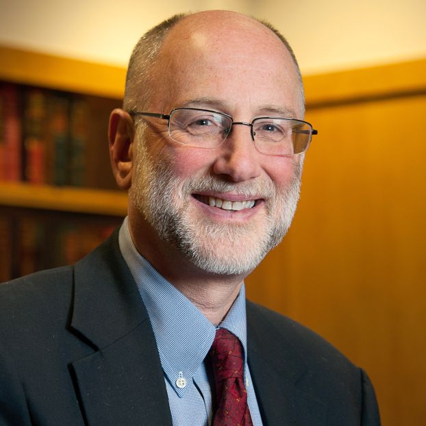 portrait of man wearing glasses in a suit and tie