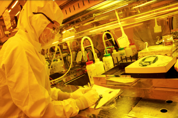 A person wearing protective clothing works in a laboratory.