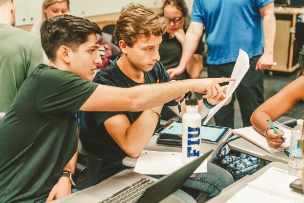 Two college students in a classroom.