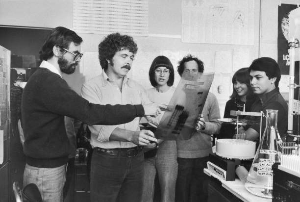 A 1970s-era photograph of researchers standing around a radiogram.