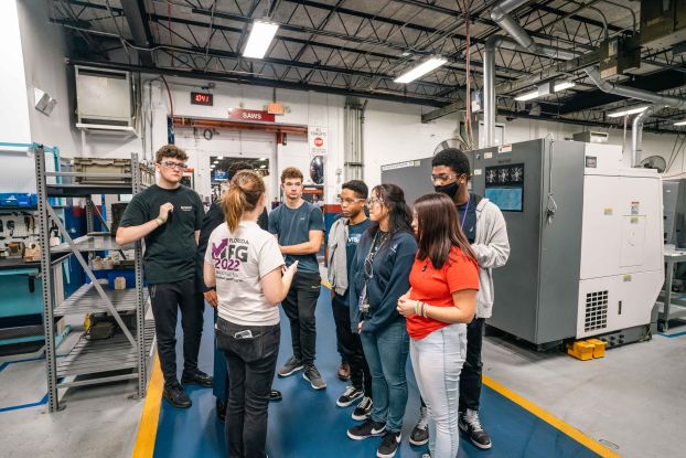 Instructor talking to group of students in computer lab