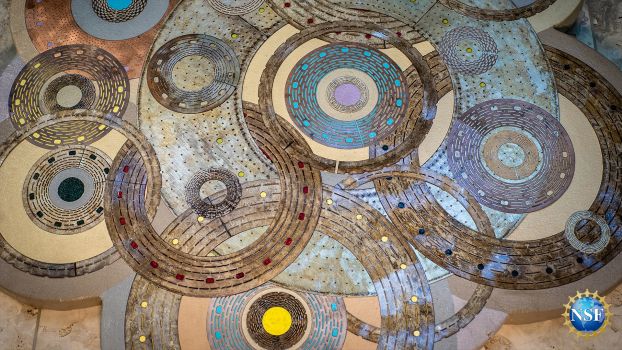 This unique art hangs in the lobby at MagLab and is crafted from the disks that make up the powerful magnets at the facility.