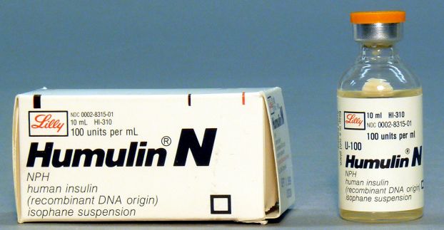 A vial of insulin next to a box labeled "Humulin N".