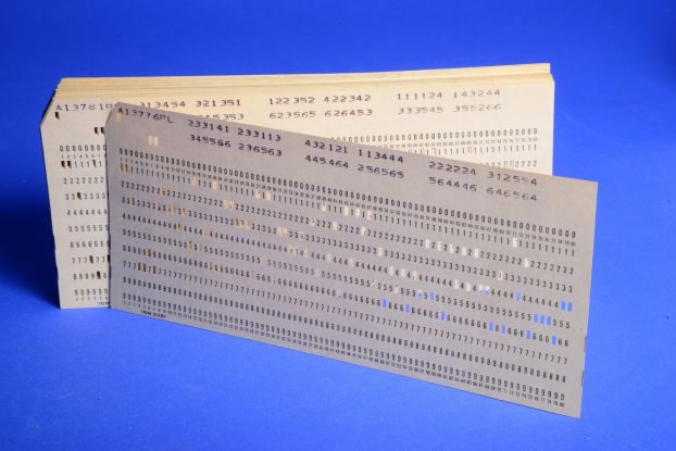 A standard eighty-column paper punch card containing a series of punches.