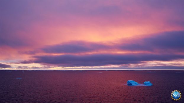 Dramatic image of arctic ice in the middle of arctic ocean with beautiful sky in the background.