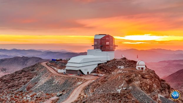 Rubin Observatory at sunset within a mountainscape