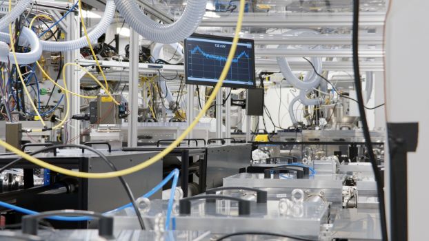 A lab with a computer monitor surrounded by wires and tubing hanging from the ceiling.