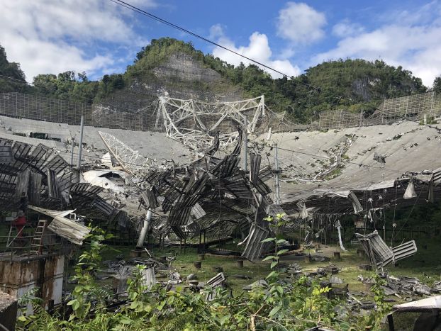 Damage to the 305-meter telescope at Arecibo Observatory, after its collapse on Dec. 1, 2020. The remains of the instrument platform are visible on the telescope’s dish.