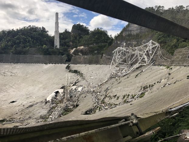 Damage to the 305-meter telescope at Arecibo Observatory, after its collapse on Dec. 1, 2020. The remains of the instrument platform are visible on the telescope’s dish.