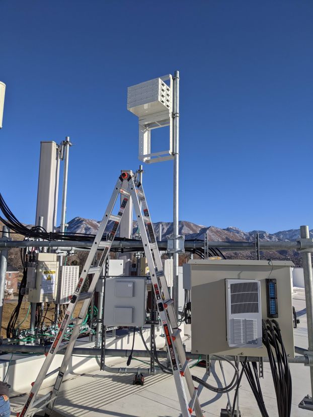 A ladder in front of communications equipment.