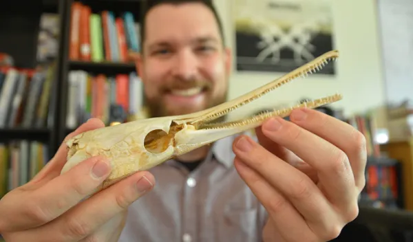 man holding fish skull