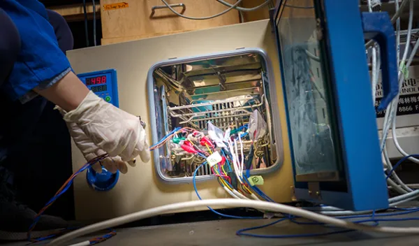 scientist working on wires in a machine