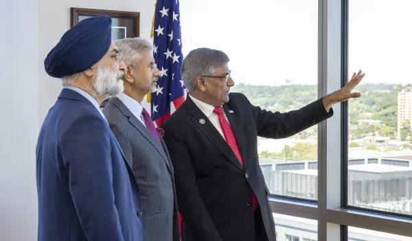 Minister Jaishankar, Ambassador Sandhu, and NSF director Panch standing in front of US flag