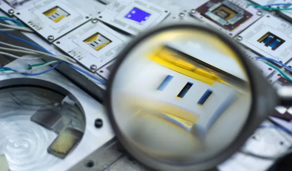 Magnifying glass held up to solar cell components