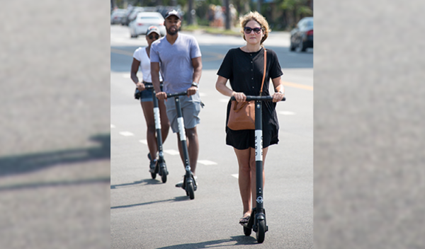 people riding electric scooter