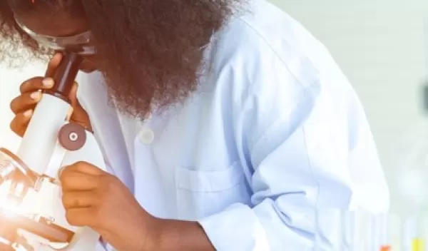 woman looking the microscope