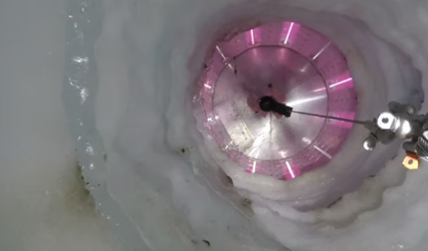 Instruments descend 1,100 meters (3,500 feet) down a borehole to Antarctica's Mercer Subglacial Lake. The UV collar of the borehole lights up, irradiating any sources of contamination.
