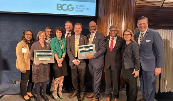 NSF Director Sethuraman Panchanathan stands for a group photo with NSF staff, including CISE DAD Joydip Kundu, CISE AD Margaret Martonosi, COO Karen Marrongelle, OIRM CHCO Wonzie Gardner, CISE COO Brian Stone, and others holding NSF's 2022 Best Places to Work in the Federal Government® awards.