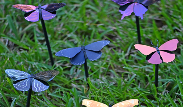 Plasmonic paint uses colorless materials instead of pigments to create colors. Shown: the paint on metal butterflies, the insects that inspired the research.