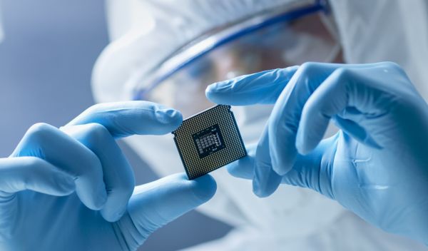 lab worker holds computer chip