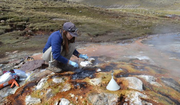 Geoscientist Heather Upin collects a microbial sample from Aguas Calientas Pinaya in Peru's southern Andes.
